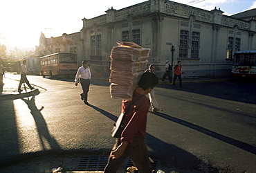 Morning activity on the streets, boy carrying newspapers, San Jose, Costa Rica, Central America