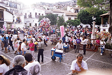 Ice cream vendor in middle of crowds during Easter celebratioans, Taxco, Mexico, North America