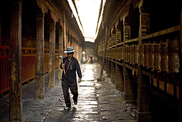 Man circuits the inner Jokhang temple, walking the circumambulation pathway (Nangkhor), Jokhang Temple, Barkhor, Lhasa, Tibet, China, Asia