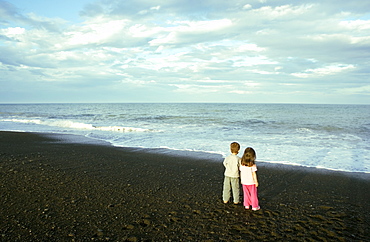 Two young children, boy and girl, on the beach at Napier, North Island, New Zealand, Pacific