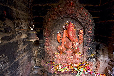 Shrine to the Hindu elephant headed god, Ganesh, including bell to alert the god to offerings made, in Patan, near Kathmandu, Nepal, Asia