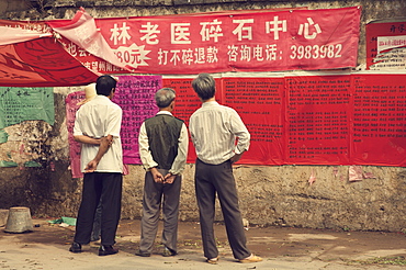 Chinese people reading announcement, Xingping, Guangxi Province, China, Asia