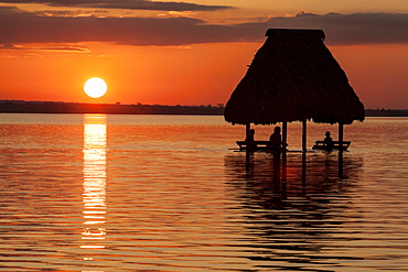 People relaxing at sunset, Lago Peten Itza, El Remate, Guatemala, Central America