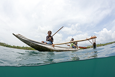 Family in Outrigger Canoe, Tufi, Cape Nelson, Papua New Guinea