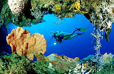 scuba diver and underwater cave, Papua New Guinea, Pacific ocean