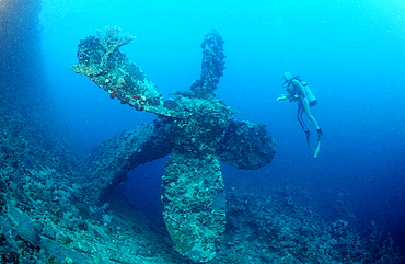 Scuba diver and propellor of Umbria shipwreck, Wingate Reef, Sudan, Red Sea, Africa