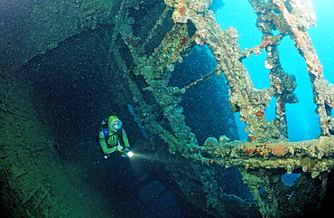 Scuba diver diving on Umbria shipwreck, Wingate Reef, Sudan, Red Sea, Africa