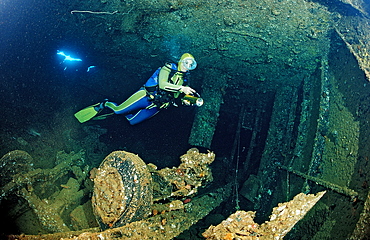 Scuba diver and truck wreck in Blue Belt shipwreck, Sudan, Red Sea, Africa
