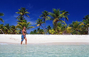 Woman walking on sandy beach, Catalina Island, Dominican Republic, West Indies, Caribbean, Central America