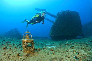 Diver finds Lamp in Front of Twin 8-inch 55 caliber Gun on USS Saratoga, Marshall Islands, Bikini Atoll, Micronesia, Pacific Ocean