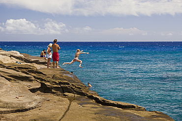 Tourists at Chinawall Rocks at Kawaihoa Point, Oahu, Pacific Ocean, Hawaii, USA