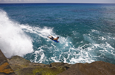 Tourists surfing at Chinawall Rocks at Kawaihoa Point, Oahu, Pacific Ocean, Hawaii, USA