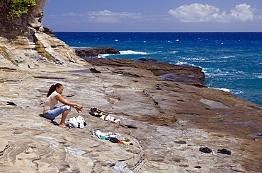 Tourist at Chinawall Rocks at Kawaihoa Point, Oahu, Pacific Ocean, Hawaii, USA