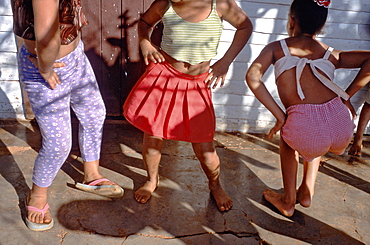 Young girls dancing in the street in the town of La Serafina in La Habana Province, Cuba