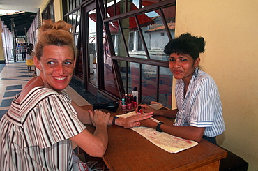 Nueva Gerona, main street, with beautician doing nails, Isle of youth, Cuba