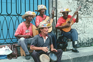 The Los Mambises Band performing on the sidewalk in Havana Vieja, Havana, Cuba