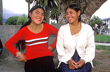 Teenage students on the main plaza of Otavalo, a town famous for its colorful craft and produce market, North of Quito, Highlands, Ecuador