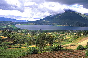 Imbabura Volcano, 4609, meters high, above the waters of Laguna San Pablo with the fields around the town of Otavalo in the foreground, North of Quito, Highlands, Ecuador