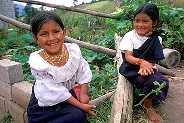 Young sisters in traditional Otavalo dress on their family's farm above Laguna San Pablo and the town of Otavalo, North of Quito, Highlands, Ecuador