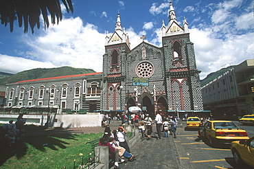 Banos resort and famous hot springs in semitropical area Basilica of Senora de Agua Santa, facade of church on main plaza, Highlands, Ecuador