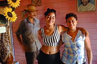 A mother, father and daughter in their home in La Serafina in the Province of La Habana in central Cuba, Cuba