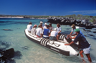 Hood Island tourists in inflatable raft with naturalist during an ecotourism trip, Galapagos Islands, Ecuador