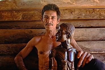 A wood sculptor with a carving in his shop in Baracoa in eastern Cuba