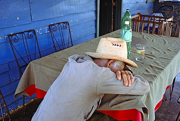 Portrait of a campesino farmer sleeping on the porch of his home in La Habana Province in central Cuba, Cuba