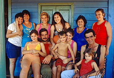 Extended family in front of their farmhouse near Guira de Melena in the Province of La Habana in central Cuba, Cuba