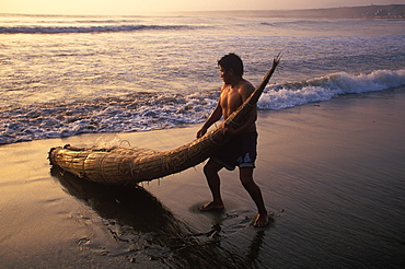 Caballitos de totora', small fishing boats woven of totora reeds in a style unchanged since pre-Inca times at Huanchaco beach, Trujillo, North Coast, Peru