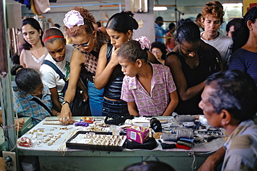 Women shopping for jewelry in a shop in the Capital City, Habana Vieja, Havana, Cuba