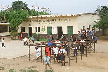 Small rural school and students in playground during recess, in town of San Jose de Moro outside Pacasmayo south of Chiclayo, North Coast, Peru