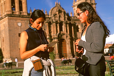 Ancient capital of the Incas the Plaza de Armas in the colonial center of the city Peruvian students with the Cathedral beyond, Cuzco, Highlands, Peru