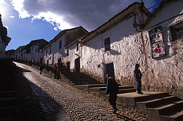 Traditional homes, constructed of adobe and tile, lining the streets that climb the very steep hills surrounding Cuzco, Highlands, Peru