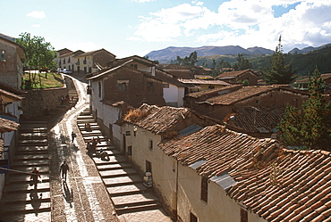 Traditional homes, constructed of adobe and tile, lining the streets that climb the very steep hills surrounding Cuzco, Highlands, Peru