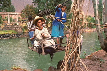 Small cable car holding passengers suspended over the Urubamba River near Cuzco useful technology where there are no bridges, Andes Mountains, Highlands, Peru