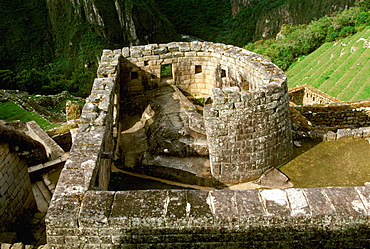 Machu Picchu the Temple of the Sun with the site's most perfect stonework encloses a rock below aligned window to indicate the solstice, Highlands, Peru