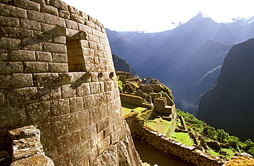 Machu Picchu the Temple of the Sun with the site's most perfect stonework encloses a rock below aligned window to indicate the solstice, Highlands, Peru