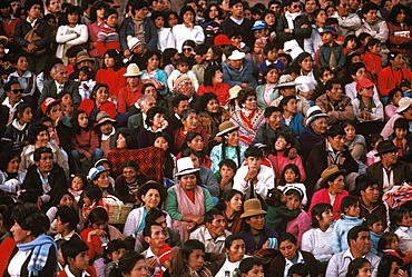 Corpus Christi Festival in Cuzco spectators sitting on the steps below the Cathedral watching the procession in the Plaza de Armas, Peru