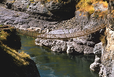 Famous Incan grass-rope suspension bridge across Apurimac River rebuilt annually since Incan period and only one still in existence, Inca Road, Altiplano, Peru