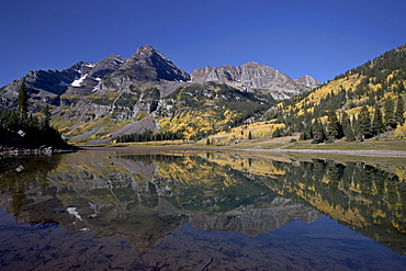 Maroon Bells reflected in Crater Lake with fall color, White River National Forest, Colorado, United States of America, North America