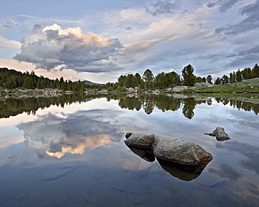 Clouds at sunset reflected in an unnamed lake, Shoshone National Forest, Wyoming, United States of America, North America