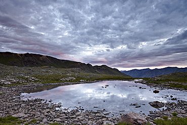 Clouds reflected in a tarn at Stony Pass, San Juan National Forest, Colorado, United States of America, North America