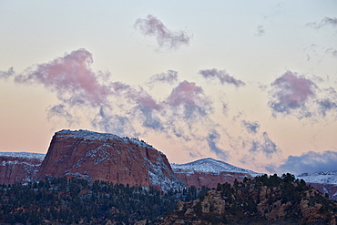 Pink clouds at dawn over sandstone formations covered with a dusting of snow, Zion National Park, Utah, United States of America, North America