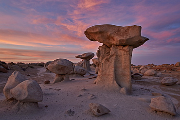 Hoodoos at dawn under red clouds, Bisti Wilderness, New Mexico, United States of America, North America