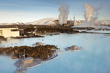 People relaxing in Blue Lagoon geothermal spa, Svartsengi Geothermal Power Station in the distance, Grindavik, Reykjanes Peninsula, Iceland, Polar Regions