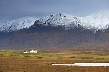 Laekjamdt farm, snow-covered Vididalsfjall mountain behind, near Blonduos, north coast, Iceland, Polar Regions
