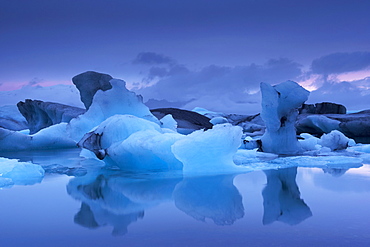 Icebergs in Jokulsarlon glacial lagoon, at dusk, East Iceland, Iceland, Polar Regions