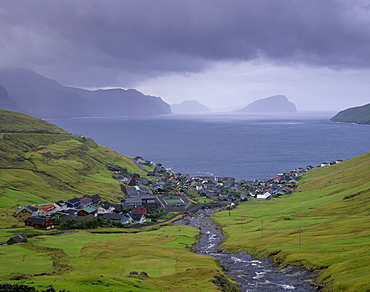 Village of Kvivik and Stora river, view on Vestmannasund, Streymoy coastline, Koltur and Hestur in the distance, Streymoy, Faroe Islands (Faroes), Denmark, Europe