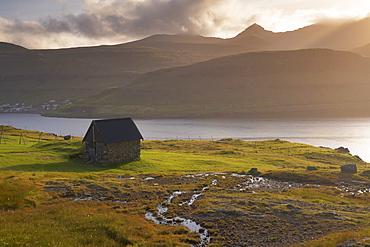 Streymoy mountains seen across Sundini sound, from near Eidi, on the north-west tip of Eysturoy, Faroe Islands (Faroes), Denmark, Europe